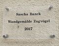 Schild zur Fassadengestaltung „Zugvögel“ des Gebäudes Georgenstraße 36, <!--LINK'" 0:80-->, September 2025
