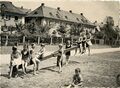 Spielende Kinder auf einer Wippe zwischen der Widder- und Georgenstraße im Espan, vierte von links: Hedwig Gellinger; fünfte von links (Bildmitte stehend vor der Wippe): Dagmar Solomon, ca. 1933