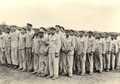 Dachau, Germany, Inmates at a roll-call, 1938 (Dachau, Häftlinge beim Appell, 1938)</br>
Standing third from left in the front row is Jakob Koschland,</br><i>Identified by his Son Bernd Koschland</i>